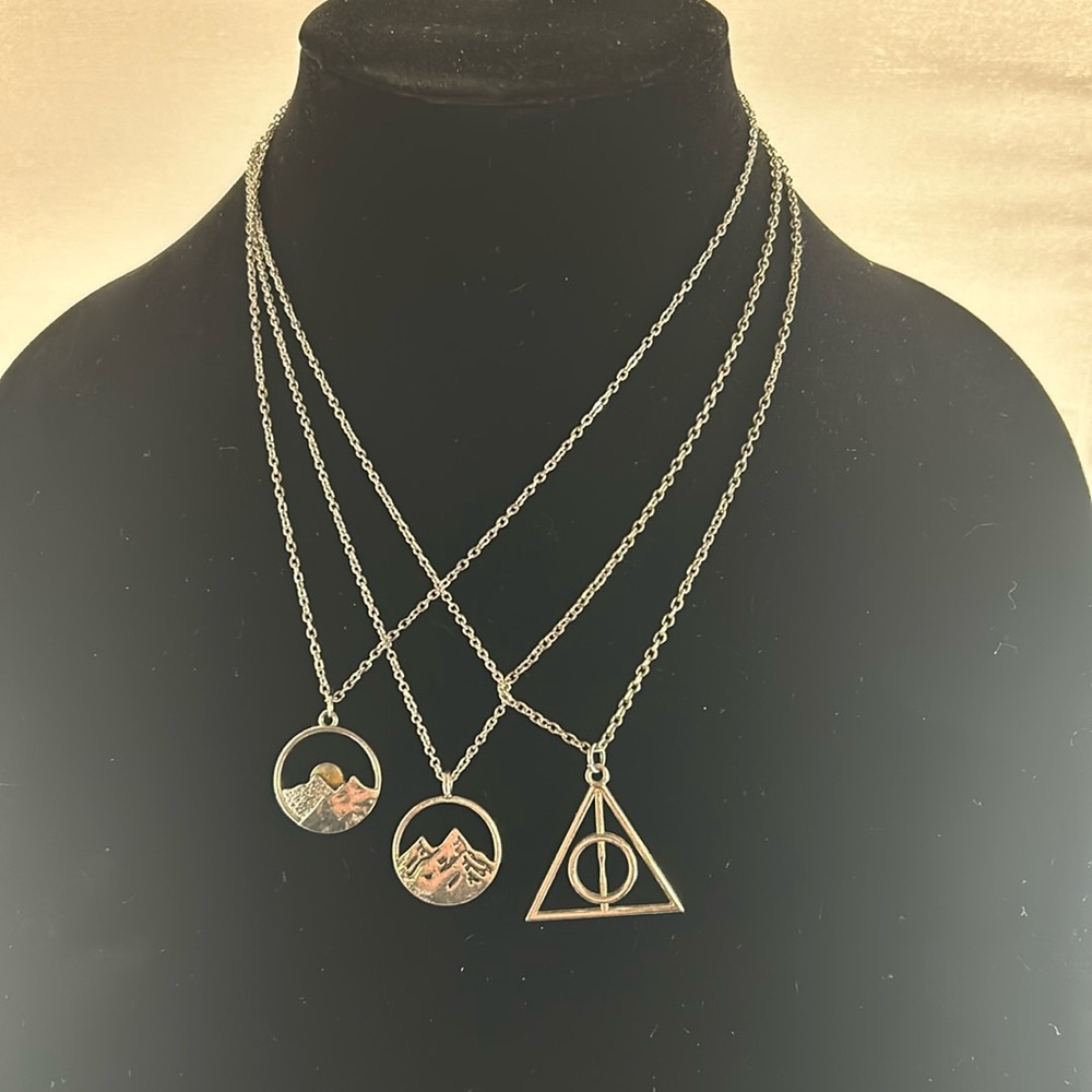 3-Silver colored costume jewelry necklaces. Sold together.